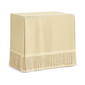 May include: A beige rectangular table cover with a fringe trim. The cover is made of a solid, neutral-toned fabric. The fringe is a lighter shade of beige and hangs along the bottom edge.