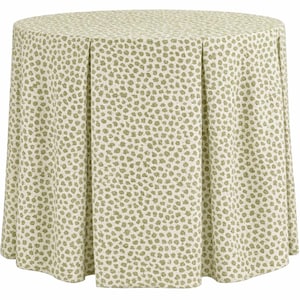 May include: A round table covered with a pleated tablecloth. The tablecloth has a cream-colored background with a pattern of small, light green floral shapes. The table is fully covered.