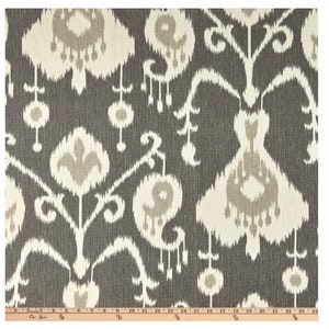 May include: Gray and white fabric with an ikat pattern. The pattern features a repeating design of stylized flowers and leaves.