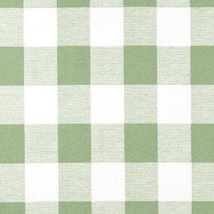 May include: A close-up of a fabric with a large gingham pattern in white and a soft green color. The fabric is a woven material with a textured appearance. A wooden ruler is at the bottom of the image.