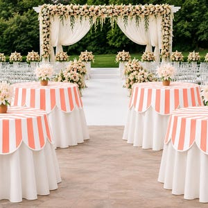 May include: Outdoor wedding reception setup with round tables featuring coral and white striped tablecloths. Each table has a vase of flowers. A floral archway and rows of chairs are in the background.