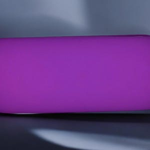May include: A bright purple, oval-shaped, soft, plush cushion.