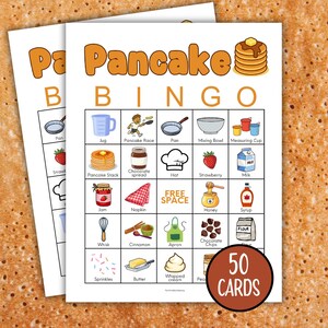 May include: Two white cards with a brown border featuring a colourful pancake bingo game. The game includes illustrations of pancake-related items like syrup, strawberries, and chocolate chips. The words "Pancake Bingo" are at the top.