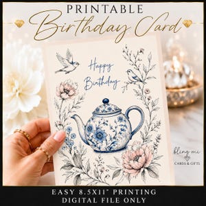 May include: A printable birthday card featuring a blue and white teapot illustration surrounded by pink flowers, leafy branches, and two small birds. The text reads "PRINTABLE Birthday Card" at the top and "Happy Birthday" in the center.