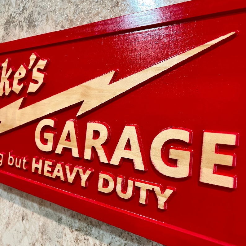 May include: Red wooden sign with a white lightning bolt and the text "Mike's Garage - Nothing but Heavy Duty".
