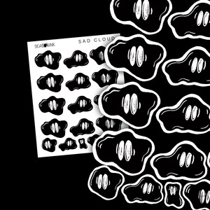 May include: A sheet of stickers featuring black cloud shapes with white eyes and the text "SAD CLOUD". The stickers are on a white background with the brand name "SEASINK" visible. Additional cloud stickers are scattered on a black background.