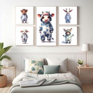 May include: Four framed illustrations of animals wearing pajamas. The animals are a pig, a cow, a goat, and a donkey. The illustrations are in a white frame and are hanging on a white wall.