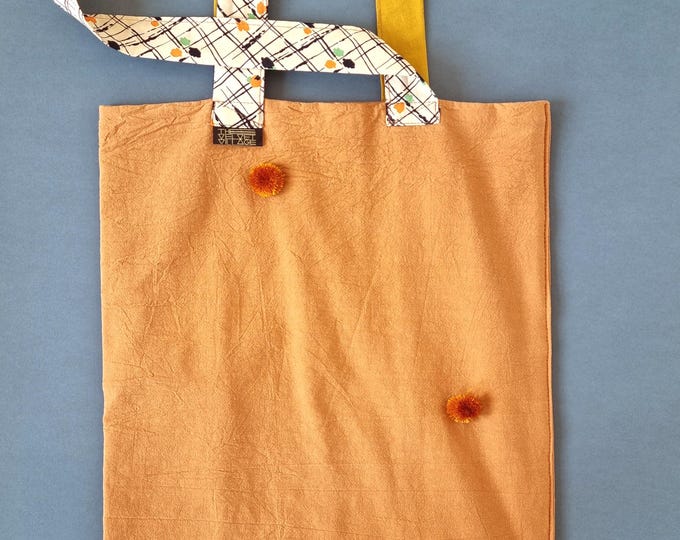 Handmade tote bag using upcycled burnt orange natural fabric