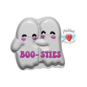 May include: White silicone mold of two ghosts hugging, with the text "BOO-STIES" in pink letters. The mold is labeled "Molded from Love" with a heart and wings.