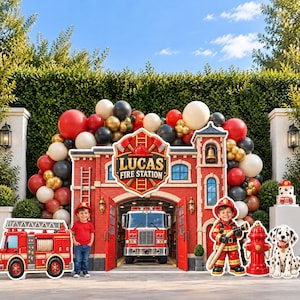 May include: A fire station-themed party backdrop featuring a red brick building facade with the text Lucas Fire Station, a central fire truck, a balloon arch, a cutout of a child in a red shirt, a firefighter cutout, and a dalmatian dog.