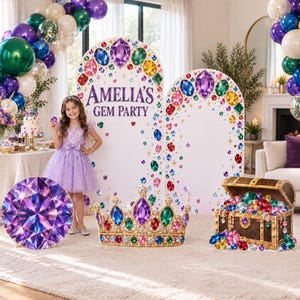 May include: A party display featuring two large arched panels with colorful gem illustrations and the text AMELIA'S GEM PARTY. Includes a circular purple gem sign, a gold crown cutout with jewels, and a wooden treasure chest overflowing with faux gems.