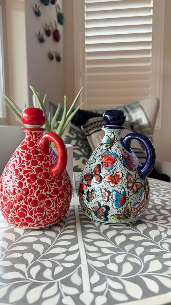 A hand-painted Talavera olive oil dispenser with floral and butterfly motifs — 40 favorites don't lie; this is a functional art piece that makes every kitchen counter look intentional.