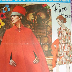 May include: Vintage sewing pattern for a red cape and a geometric print dress. The pattern is by Pucci of Italy and the pattern number is 2231.