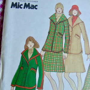 May include: A vintage sewing pattern from Young Designer Mic Mac featuring three women wearing different outfits. The woman on the left is wearing a green trouser suit with a red trim. The woman in the centre is wearing a plaid skirt and jacket. The woman on the right is wearing a brown jacket and skirt.