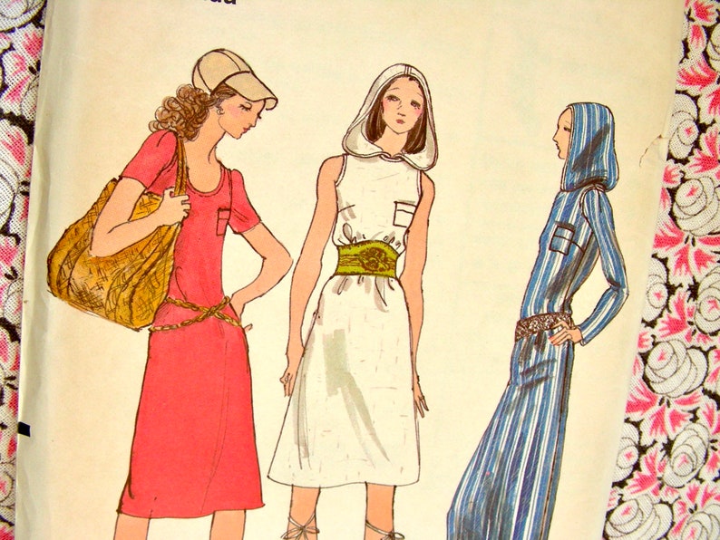 May include: Three women's dresses, one red, one white, and one blue and white striped. The red dress has short sleeves and a scoop neck. The white dress has a hood and a sleeveless design. The blue and white striped dress has long sleeves and a hood. All three dresses have a belt.