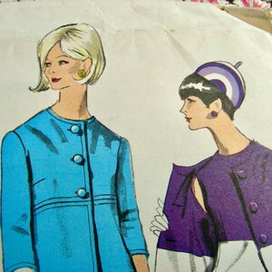 May include: A vintage sewing pattern featuring two women wearing different styles of jackets. The woman on the left is wearing a light blue jacket with buttons, and the woman on the right is wearing a purple jacket with a white collar and cuffs. The pattern includes the text "Hip 34" and "U.S. Canada".