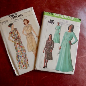 May include: Two vintage sewing patterns for dresses. The Vogue pattern is for a floral print dress with a tie waist. The Simplicity pattern is for a long, flowing dress with a tie waist and long sleeves. Both patterns are in white with black text.