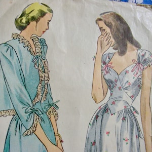 May include: Vintage sewing pattern illustration featuring two women in elegant dresses. One woman is wearing a light blue jacket with ruffled trim and bows. The other is in a floral print dress with pink bows on the shoulders.