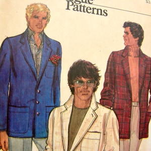May include: Three men's fashion pattern illustrations. The first man is wearing a blue blazer with a white and blue patterned shirt. The second man is wearing a white blazer with a brown shirt. The third man is wearing a red and black plaid blazer with a brown shirt. The text "Vogue Patterns" is printed at the top of the image.