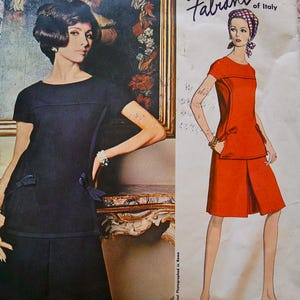 May include: Vintage Vogue Couturier Design sewing pattern 1555 by Fabiani of Italy. The cover features a woman in a dark navy dress and a fashion illustration of a woman in a red dress. The text "Fabiani Original Photographed in Rome" is visible.