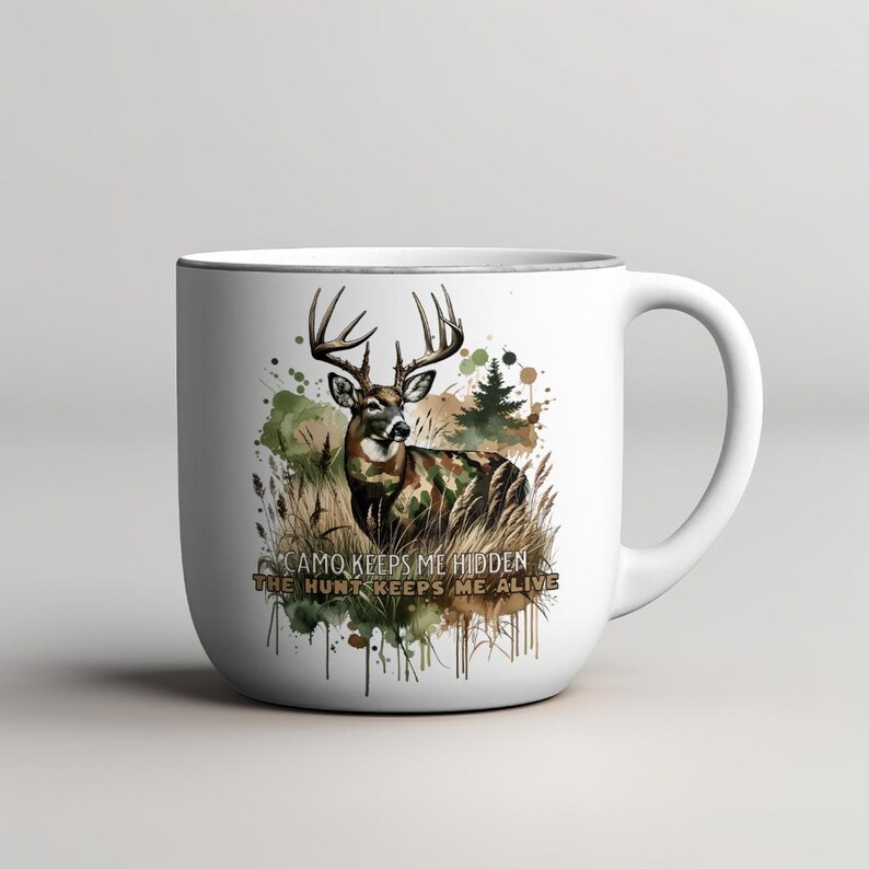 May include: White ceramic mug featuring a watercolour design of a deer in camouflage with the text "Camo keeps me hidden, the hunt keeps me alive".