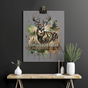 May include: A watercolour painting of a deer in camouflage with the text "CAMO KEEPS ME HIDDEN THE HUNT KEEPS ME ALIVE".