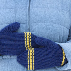 May include: A pair of navy blue knitted mittens with yellow stripes. The mittens are thick and warm, perfect for cold weather. The yellow stripes are on the cuffs and around the top of the mittens.