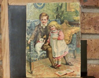 Vintage Victorian print of girl and boy with their white kitty / daffodils and cattails, blue couch in living room