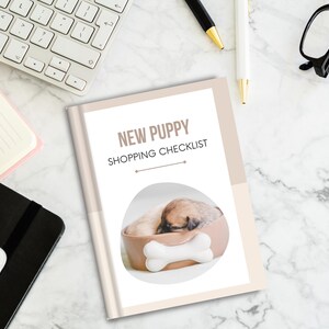 May include: A beige and white checklist titled "New Puppy Shopping Checklist" with a photo of a small puppy sleeping in a brown dog bed with a white bone.