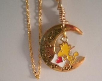 Tiny bird wood stock style yellow bird love you to the moon love letter necklace on 24 inch gold plated chain. Wood stock holding a letter