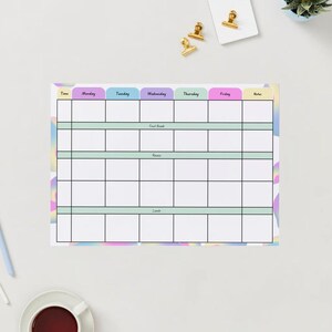 May include: A weekly planner with a pastel rainbow background. The planner has columns for each day of the week, Monday through Friday, and a notes column. The planner has rows for "Time", "First Meal", "Second Meal", and "Lunch".