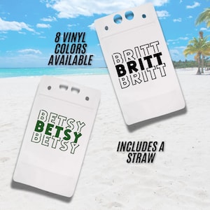 May include: Two white badge holders with the names "BRITT" and "BETSY" printed in black and green. The text "8 VINYL COLOURS AVAILABLE" and "INCLUDES A STRAW" are also visible. The background is a beach scene with a blue sky and palm trees.