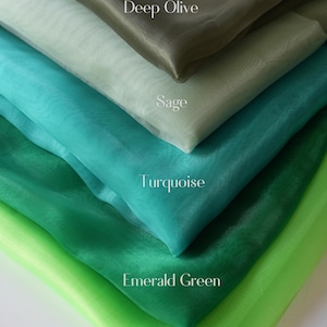 May include: A layered display of sheer fabric in shades of green and blue. The colors include deep olive, sage, turquoise, emerald green, and lime. The text labels each color. The brand name "Lalathread" is in the bottom left corner.