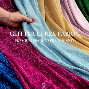 May include: A display of shimmering glitter lurex fabric in various colors, including blue, gold, pink, and green. The fabric is labeled "Glitter Lurex Fabric" and "Premium Sparkle Stretch Knit". The fabric is being held by a hand with a red painted nail.