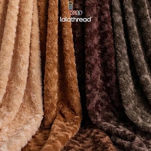 May include: A collection of plush fabric swatches featuring a swirling rose pattern in shades of beige, tan, brown, and dark gray. The fabric has a soft, textured surface with a visible logo reading lalathread at the top center of the image.