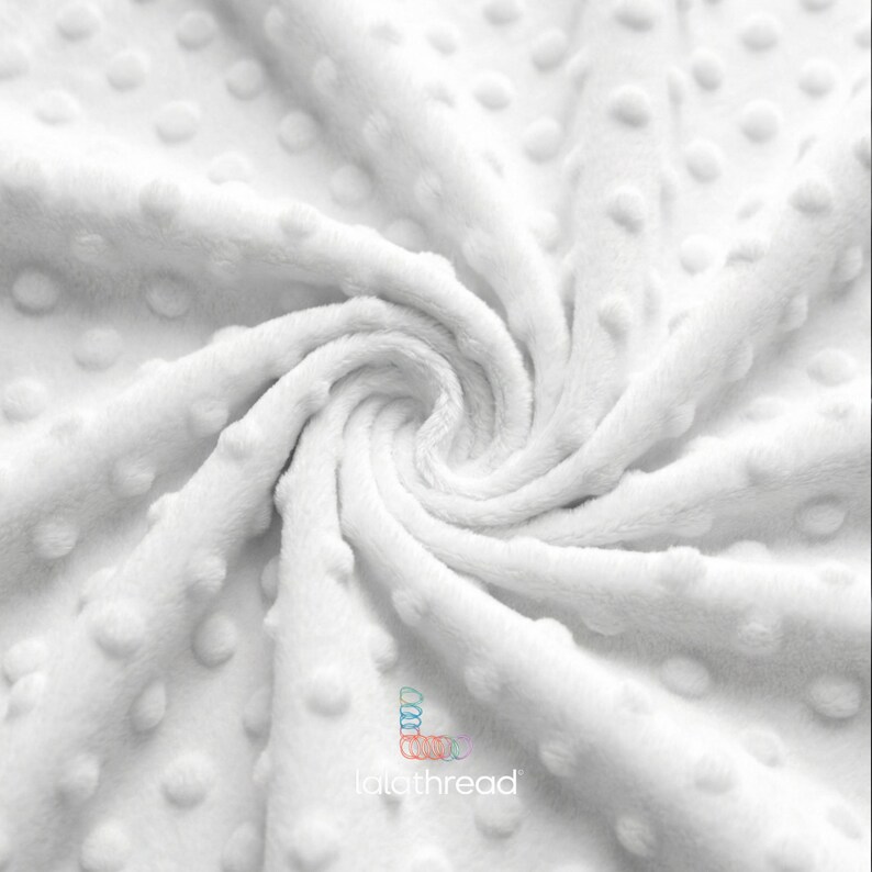 May include: A close-up shot of a white fabric with a textured, raised dot pattern. The material is arranged in a swirl, creating a spiral effect. The logo "lalathread" is visible.