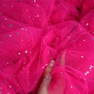 May include: Bright pink tulle fabric with silver star and moon sequins. The fabric is gathered and layered, creating a voluminous effect. The brand name "lalathread" is visible in the upper right corner.