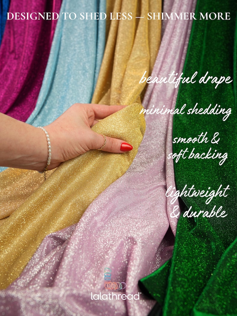 May include: A hand holds a swatch of gold fabric from a collection of shimmering textiles. The image features various colors, including pink, green, blue, and gold. Text on the image reads "Designed to shed less - shimmer more" and highlights features like "beautiful drape" and "lightweight & durable."