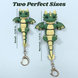 May include: Two dragon keychains in green and yellow, one 3.25 inches and the other 4.5 inches. The keychains have a gold-colored clasp. The text "Two Perfect Sizes" is at the top.