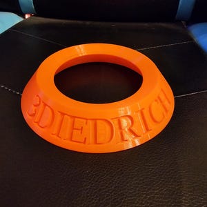 May include: An orange plastic ring with the word "DIEDRICH" embossed on it.