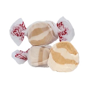 May include: Three individually wrapped peanut butter and vanilla flavored salt water taffy candies. The taffy is white and brown with swirls of each color.
