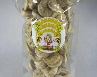 May include: A clear plastic bag filled with dried banana chips. The bag has a label with the text "Grandma Susan's Organic Candy" and a cartoon monkey.