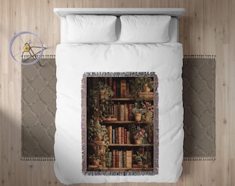 May include: A woven throw blanket featuring a detailed illustration of a bookshelf filled with books and plants. The design includes various book sizes and colors, with potted plants and vines adding to the cozy aesthetic. The blanket has a fringed edge.