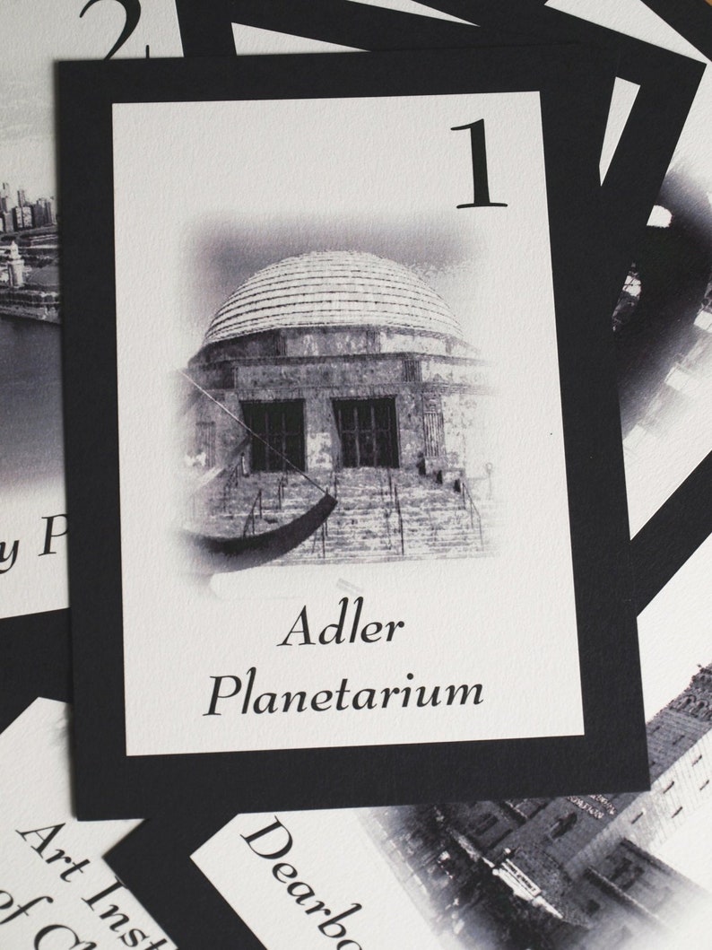May include: Black and white photo of the Adler Planetarium in Chicago, Illinois. The image is on a card with the number "1" and the text "Adler Planetarium".