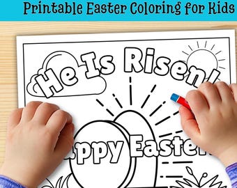 May include: Black and white Easter coloring page with the text "He Is Risen!" and "Happy Easter". A child's hands are holding the page and a red and blue crayon. The top of the page reads "Printable Easter Coloring for Kids".