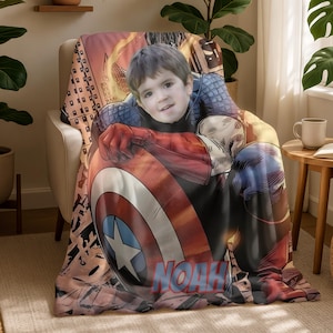 May include: A personalized Captain America-themed blanket featuring a child's face. The blanket showcases Captain America's shield in red, white, and blue, with the name "NOAH" printed at the bottom. The design includes comic book style graphics.