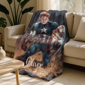 May include: A plush blanket featuring a Captain America design. The blanket showcases a comic-style illustration of Captain America, holding his shield. The name "Oliver" is written in a cursive font across the bottom of the blanket.