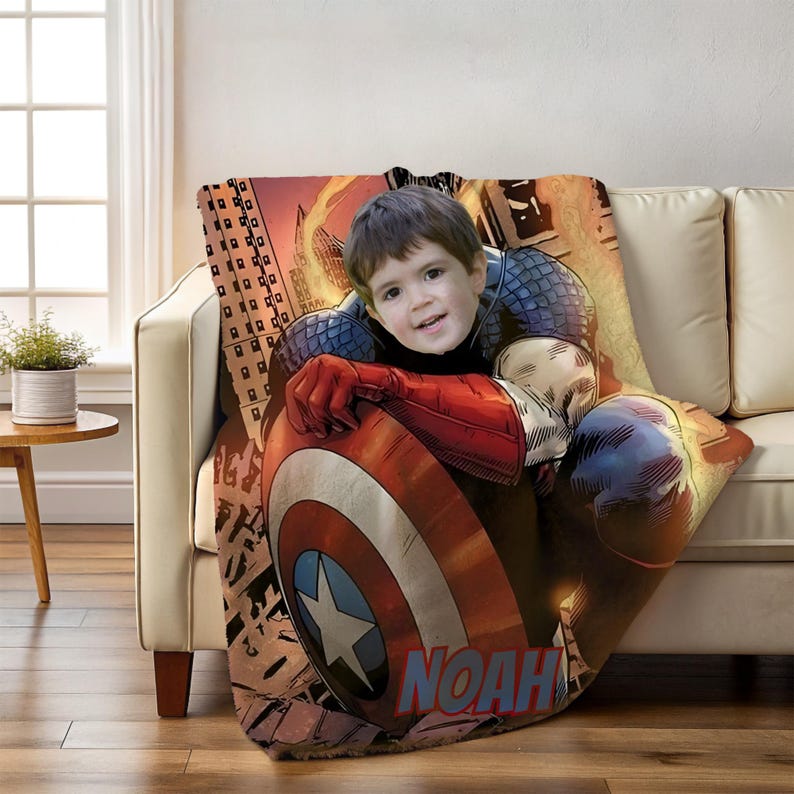 May include: A personalized Captain America blanket featuring a child's photo. The blanket showcases Captain America's shield and a cityscape background. The name "NOAH" is printed in red. The blanket is draped over a beige sofa.