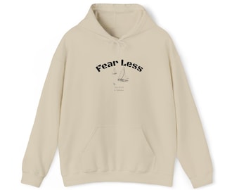 May include: A cream-coloured hoodie with a front pocket and a drawstring hood. The front of the hoodie features the text "Fear Less" in a bold, black font, with a small sailboat graphic. The hoodie is made of a soft, comfortable material.