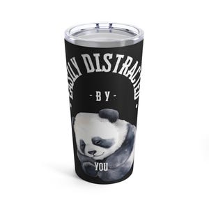 May include: A black stainless steel tumbler with a white graphic that says "Easily Distracted - By - You" and a black and white panda bear illustration.